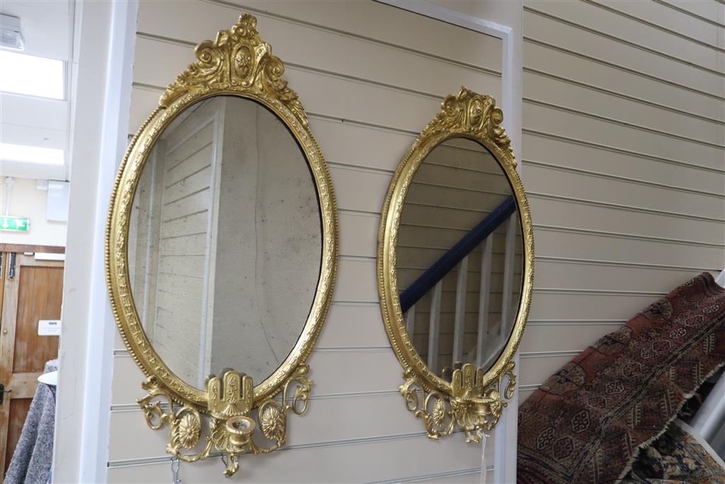 A pair of Victorian giltwood and gesso girandoles, width 46cm, height 80cm